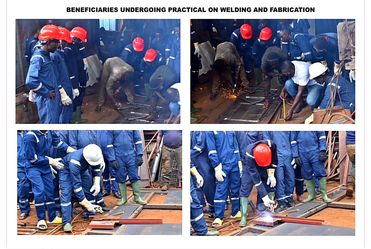 Welding sparks flying as trainees practice metal fabrication